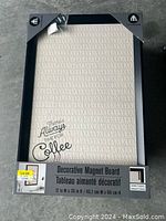 Front view of the decorative magnetic board still in packaging. Shows coffee-themed design and size.