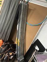 Photo of one metal vehicle ramp showing lattice surface and used condition