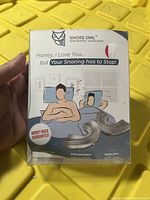 Front of the Snore Owl stop snoring aid box showing product branding, usage illustration, and money back guarantee.