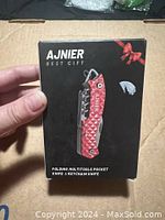 Front view of Ajnier multitool packaging showing product image and branding.