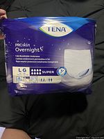 Photo of new TENA ProSkin Overnight incontinence underwear package, large size with 14 underwear in package, super absorbency.