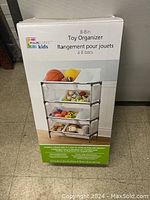 Photo of the boxed Mainstays Kids 8-bin toy organizer showing product image and branding.