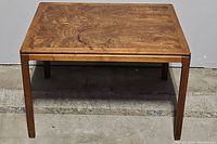Direct front view of the solid wood rectangular accent table showing surface wear and wood grain pattern.