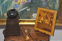 Overview photo showing all four items: black snake pot, two wooden wall plaques, and rustic wooden box.