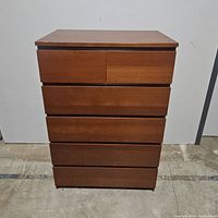 Front view of IKEA Malm 6-drawer chest showing clean medium brown wood finish in lightly used condition.