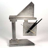 Single photo showing the entire postmodern desk clock made of airbrushed Lucite with distinct geometric design and visible clock hands.