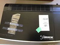 Top view showing ORECK logo, remote control taped to the top, and 50 years branding.