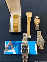 Photo showing all six men's watches in the lot, including the Seiko watch in original box
