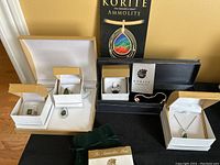 Wide view of all jewelry pieces arranged in individual boxes alongside Korite packaging.