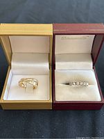 Two rings displayed side by side in boxes