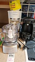 Photo showing Cuisinart food chopper with clear bowl and Hamilton Beach coffee maker with bag of coffee filters behind it.