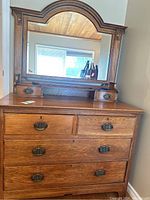 Full front view of oak dresser with attached arched mirror