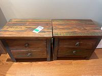Full view of two matching wood end tables showing rustic finish and two drawers each