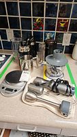 Photo showing all items including immersion blender parts, scale, chopper, frother, measuring cup, and utensils