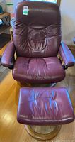 Front view of burgundy leather reclining chair and ottoman