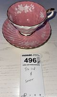 Front angle of Aynsley teacup and saucer showing pink floral design and gold trim