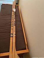 Two wooden hockey sticks side by side, showcasing the Sher-Wood and Northland branding on shaft and blade.