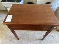 Top view of the wooden side table showing smooth finish and rectangular shape.