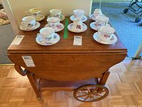 Full front and top view showing the tea trolley closed and the cups and saucers on top for scale (not included).