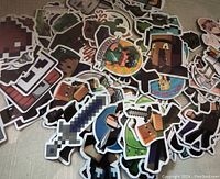 Image showing a pile of assorted Minecraft stickers featuring pixelated characters, weapons, and mobs scattered on a surface.