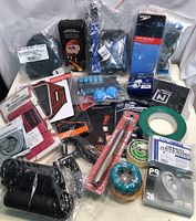 Overview photo of assortment of new fitness and sports items including grip trainers, resistance bands, tape, lubricant, ear plugs, and more.