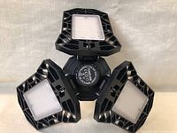 Front view of three LED socket lights showing multiple small LED lights on triangular panels.