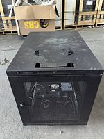 Top view of black Trip Lite rolling server rack enclosure with two cooling fans visible on top and mesh front door.
