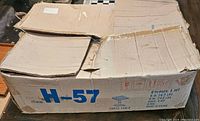 Cardboard box with item code H-57 and chess table identification.