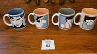 Four vintage Patrick Nagel coffee mugs displayed side by side showing different graphic art portraits.