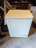 Closed view of Danby white chest deep freezer showing rectangular form and control knob on front lower right.