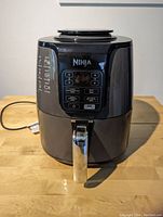 Front view of Ninja air fryer showing digital control panel and handle