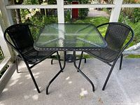 Table and two chairs on deck, overall set view