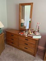 Overall view of six-drawer wood dresser with matching mirror