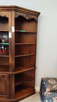 Full view of Ethan Allen wooden corner cabinet showing overall shape, finish and open shelving