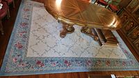 Overview of rectangular rug with dining table placed center