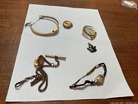 Overview of six gold filled items arranged on white background