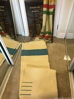 Folded blanket laid out in front of its original box showing overall appearance and packaging