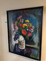 Framed oil painting of colorful floral still life, showing bouquet in a vase with a dark abstract background.