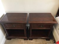 Front view of both nightstands, drawers closed showing overall styling and hardware