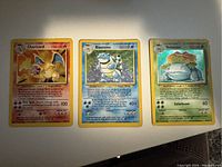 Fronts of three cards displayed side by side on white surface