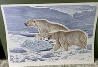 Print showing two polar bears walking on snowy terrain with a blue sky background. Signed by R.V. Stanley.