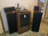 Wide shot showing cabinet flanked by five speakers
