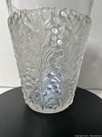 Front close-up image showing the intricate raised berry and stem design on the vase's glass surface.