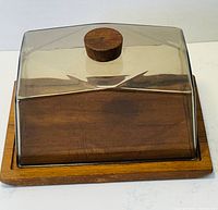 Overall view of the teak serving tray with transparent cloche showing natural wood grain and condition.