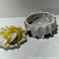 Glazed ceramic sunflower centerpiece with separate lid, showing inside of base and lid detail.