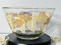 Large serving glass bowl with gold leaf and butterfly design shown from the front, highlighting details and condition.