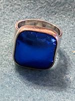 Close-up image of the front face of the vintage ring showing the square cobalt blue dichroic glass stone set in sterling silver.