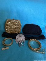 Two vintage handmade clutch purses (gold sequin and black beaded) with three stylish belts (metal coil, rhinestone, black sequin) and a rhinestone fringe accessory.