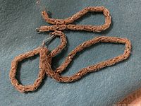 Photo of vintage brushed silver filigree necklace and bracelet set laid out on cloth, showing detailed linked pattern and overall condition.