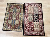 Two small area rugs laid side by side on light wooden floor, showing one with floral and geometric design, the other with patchwork floral squares and vine border.